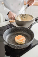 chef making pancake in kitchen