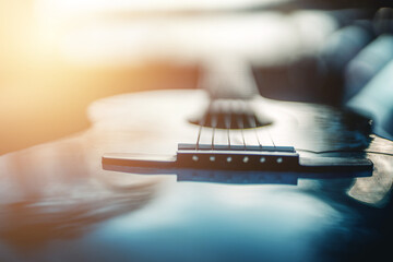 Closeup image of an acoustic guitar. - obrazy, fototapety, plakaty