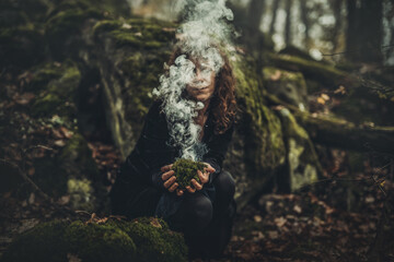 Shaman woman and incense in her hands, incense in a woman hand, ceremony space.