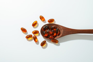 softgel in a spoon, Close up of oil filled capsules, suitable for presenting food supplements :...