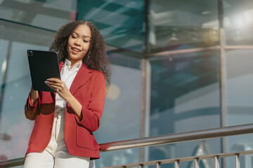 Fototapeta premium Smiling young Asian business woman leader entrepreneur, professional manager holding digital tablet computer.