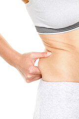 Weight gain - woman gaining weight touching fat pinching waist. Female med-section close up...