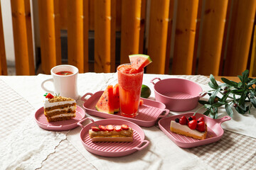 Watermelon drink and piece of cake on the table