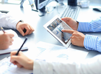 People meeting analyzing financial statistics in office. Group of business team having video conference with their team on digital tablet, remote work at home.