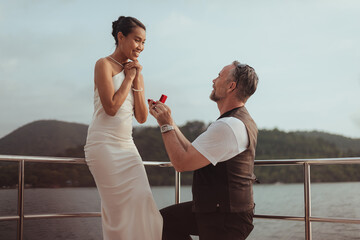 Romantic couples love get married on yachts. Happy man and woman enjoying and surprises on a cruise...
