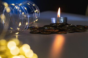 a candle on a dark background with illumination from a garland, the concept of a festive mood