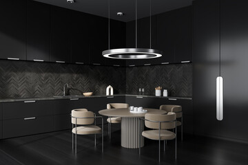Black kitchen interior with seats and eating table on hardwood floor