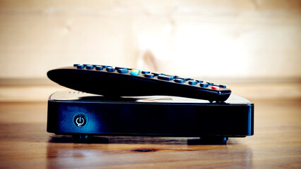 TV set-top box on a wooden background in