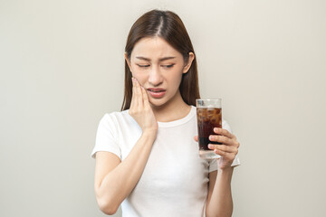 Health asian young woman touching her mouth, expression, suffering from toothache, decay or sensitivity cavity molar tooth or inflammation drink cold, sparkling water at home.Sensitive teeth people.