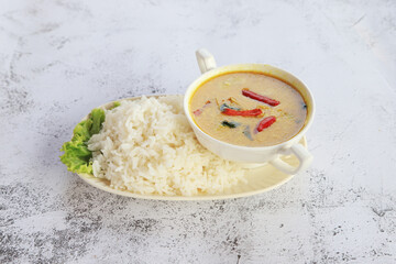 Asian food green curry with rice on the disc, green curry in bowl Thai cooking soup.