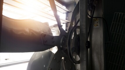 Exhaust fan blades use an electric motor drive connected to a vbelt. Ventilation blade. © Suranto