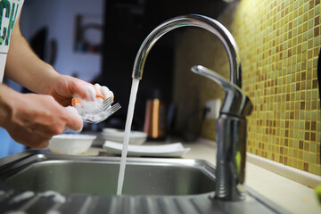 Man washing dish in sink at restaurant.People are washing the dishes too Cleaning solution