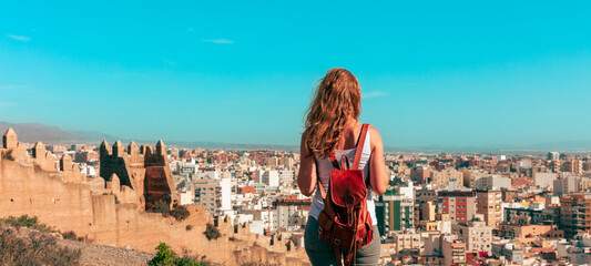 Woman tourist looking at panoramic view of Almeria city in Spain