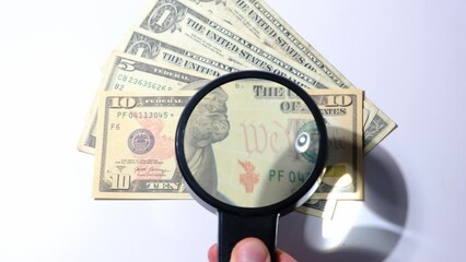 magnifying glass and money - Powered by Adobe