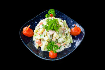 Russian salad olivie on black background side view