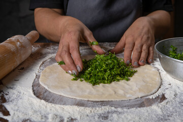 chef making dough with flour and herbs