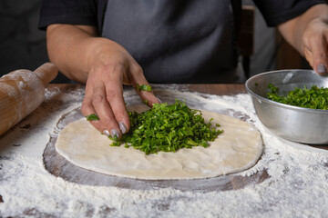 chef making dough with flour and herbs