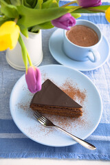 Chocolate cake, cup of coffee, and a bouquet of tulips - 559371952