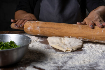 chef making dough with flour and herbs