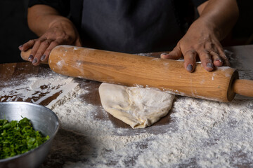 chef making dough with flour and herbs