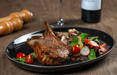 grilled beef steak with vegetables and spices on wooden table
