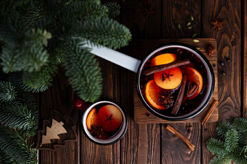 Fototapeta na wymiar A white ladle with boiled mulled wine stands on a wooden table