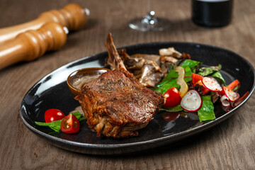 grilled beef steak with vegetables and spices on wooden table