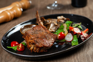 grilled beef steak with vegetables and spices on wooden table