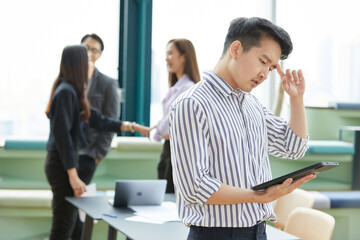 businessman working on tablet and have a headache from overworked in the office