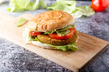 Vegan broccoli burger with lettuce and tomato. Healthy and tasty vegan dish suitable for adults and children.