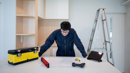 Home renovation or house remodeling concept. Asian male interior manual worker working with...