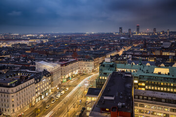 Panoramic view over the skyline of the city center of Copenhagen, Denmark, during dusk time with moody sky