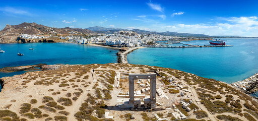 Aerial view of the famous Portara Gate at Naxos island, Cyclades, Greece, with the town and harbour behind