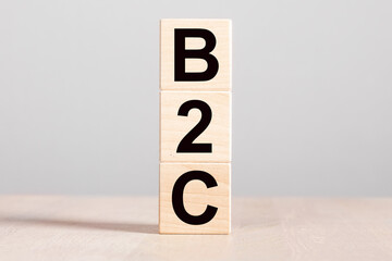 B2C acronym, business to customer client concept. Wood blocks on desk.