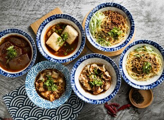 Assorted Taiwan spicy food Duck Blood, Chongqing Spicy Dumplings , Jerk Mala Noodles, Stinky Tofu, Pearl Chao Shou Dumplings, served in dish isolated on napkin top view on table