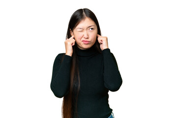 Young Asian woman over isolated chroma key background frustrated and covering ears