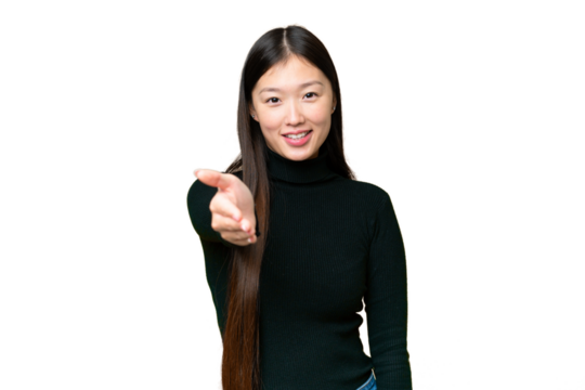 Young Asian woman over isolated chroma key background shaking hands for closing a good deal