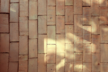 Brick wall with red bricks, brown brick background.