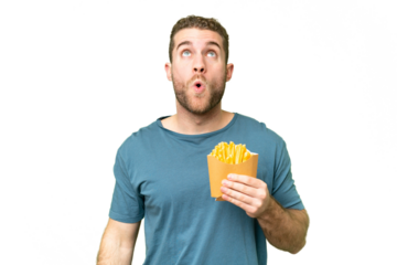 Young handsome blonde man holding fried chips over isolated chroma key background looking up and with surprised expression