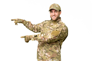 Military man over isolated chroma key background pointing finger to the side and presenting a product