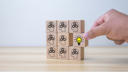 creative idea concept. hand man flip wooden block cube form human idea mark symbol to right light bulb symbol. vintage style