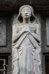 Amsterdam Bazel Building Exterior Sculpted Detail Depicting a Standing Woman with Closed Eyes and Crossed Arms, Netherlands