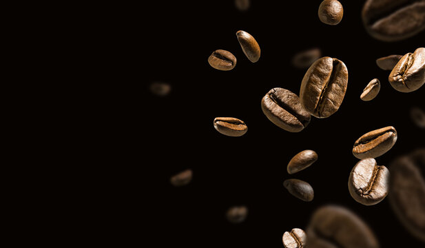 Coffee beans in flight on a dark background © butenkow