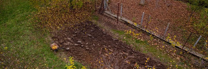 Aerial view of a ploughed vegetable garden field. Home garden prepared for winter. End of growing season.