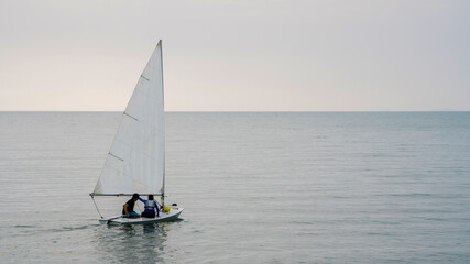 Windsurfing at sunset beatiful golden Sea horizon view. Golden Sea at Sunset with Windsurf board Sunset windsurfing. Windsurfing at sunset