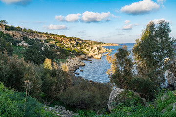 Fototapeta na wymiar Fekruna Beach a small rocky beach in Xemxija, Malt.