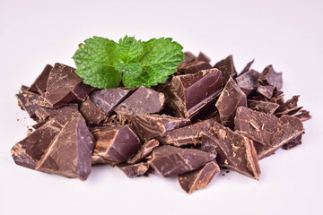 Black chocolate pieces on a white background.Close-up.	