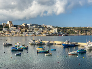 Fototapeta na wymiar Fishing boats moored in St. Paul's Bay Harbour, St. Paul's Bay, Malta.