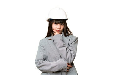 Little girl playing as a architect with helmet and holding blueprints over isolated background thinking