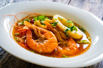 Seafood soup on wooden table
